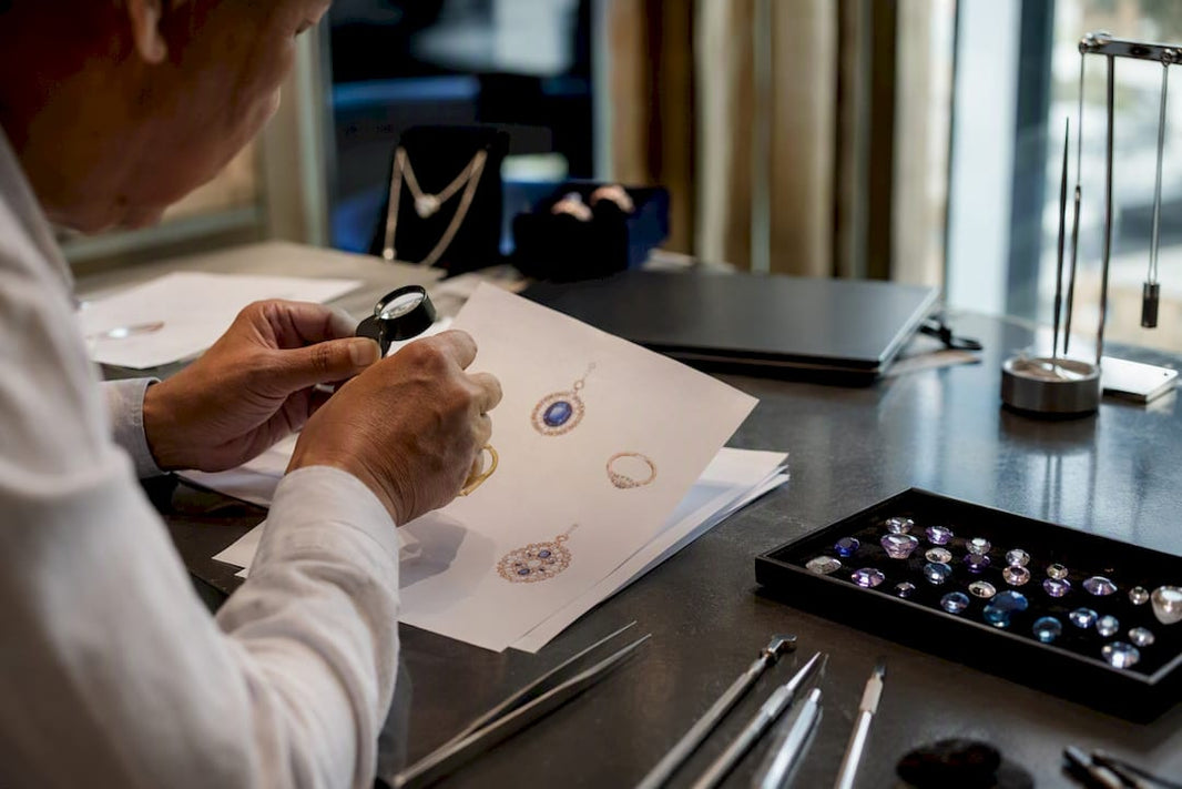 Hand inspecting jewelry catalog and stones