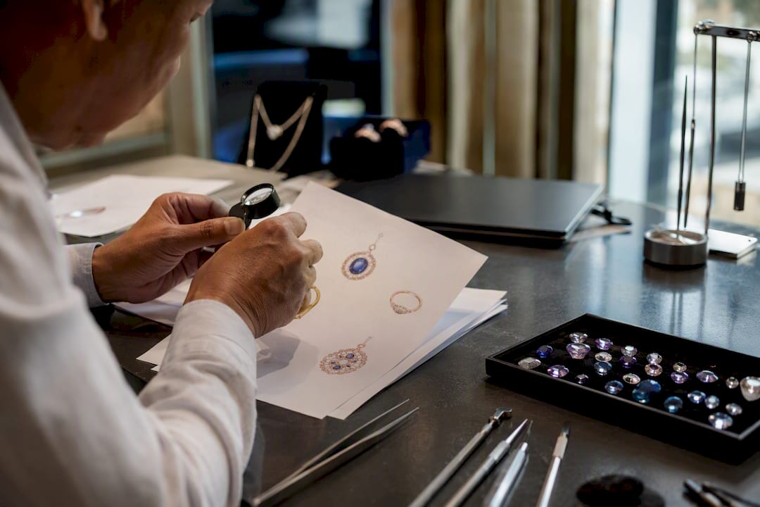 Hand inspecting jewelry catalog and stones
