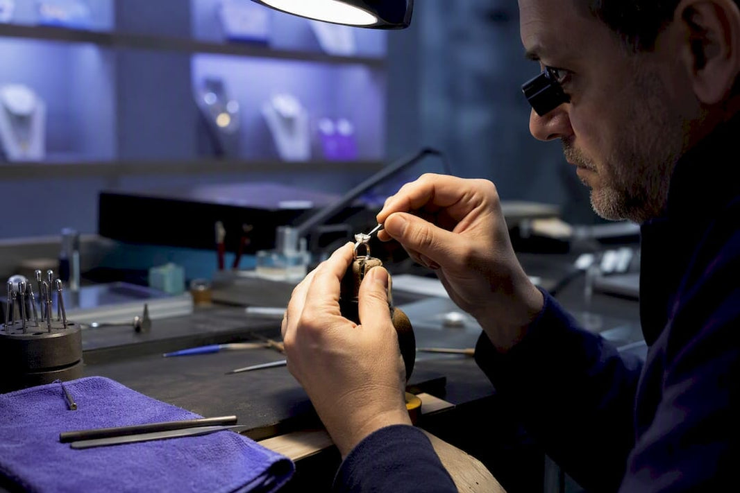 Jeweler setting stone into ring mount
