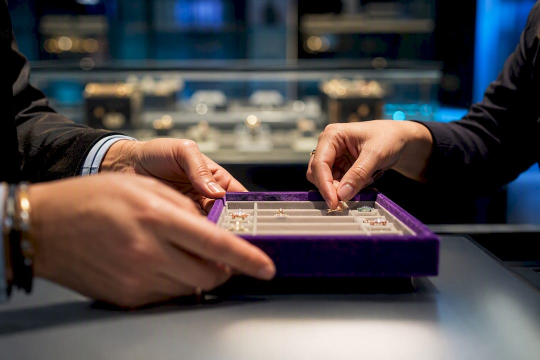 Retailer and supplier reviewing jewelry samples